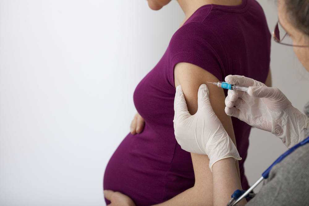 woman getting flu shot in arm