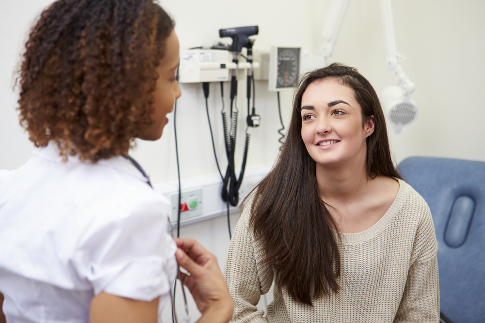 teen patient talking with female gynecology provider