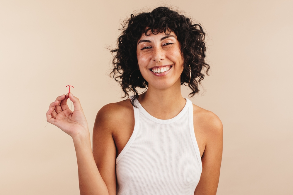 Young Woman holding IUD