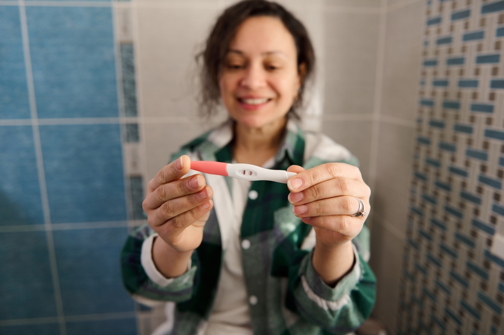 middle aged woman with positive pregnancy test