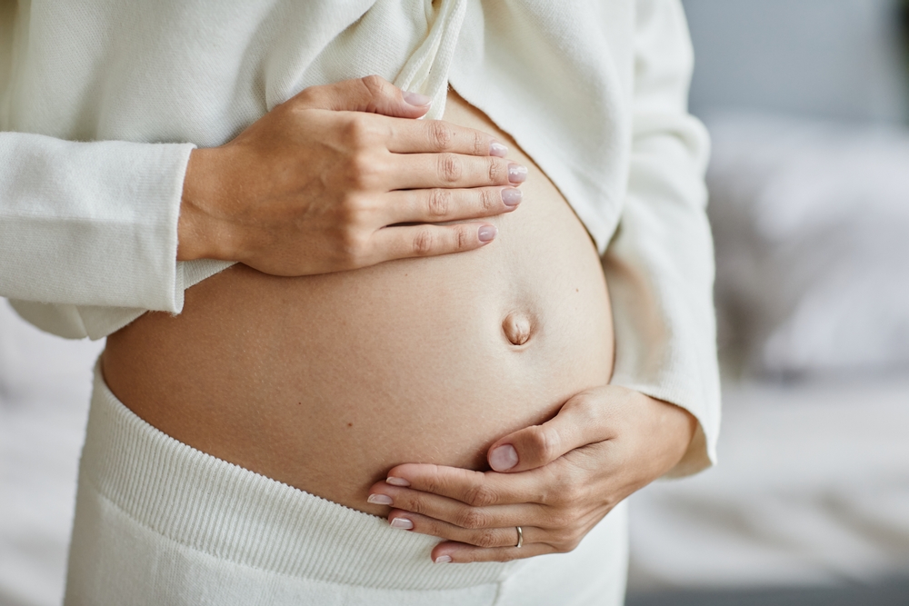 pregnant woman holding her belly