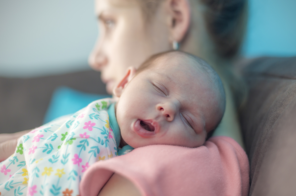 mom holding baby.